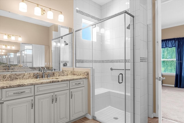 bathroom featuring vanity and a shower with shower door