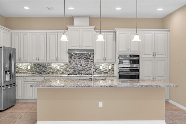 kitchen featuring sink, white cabinetry, hanging light fixtures, stainless steel appliances, and a kitchen island with sink