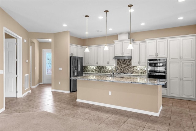 kitchen with decorative light fixtures, sink, white cabinets, a kitchen island with sink, and fridge with ice dispenser