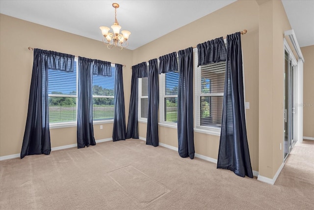 unfurnished room with light carpet and an inviting chandelier