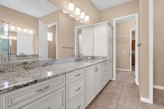 bathroom featuring vanity, tile patterned floors, and walk in shower