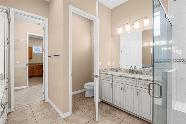 bathroom featuring an enclosed shower, vanity, tile patterned flooring, and toilet