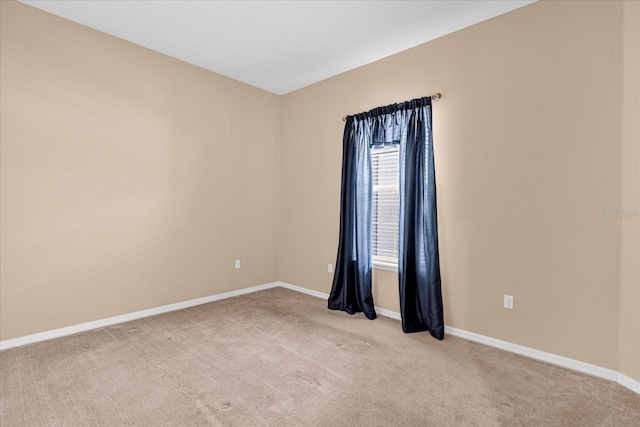 unfurnished room with light colored carpet