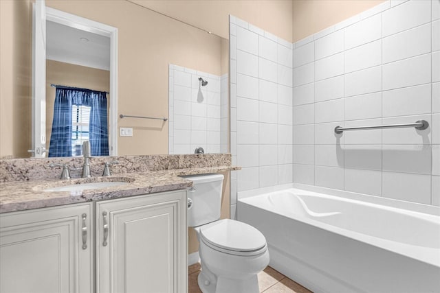 full bathroom featuring tiled shower / bath, vanity, toilet, and tile patterned flooring