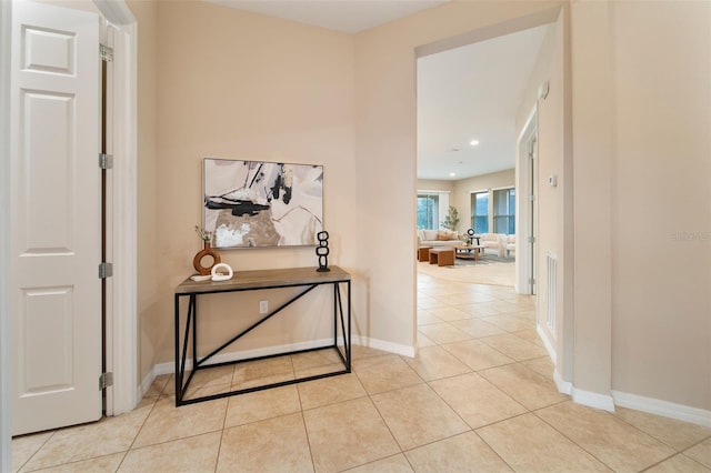 hall featuring light tile patterned floors