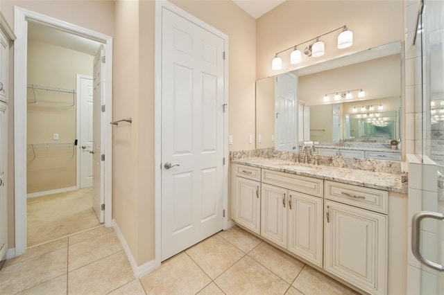 bathroom featuring vanity, tile patterned floors, and walk in shower