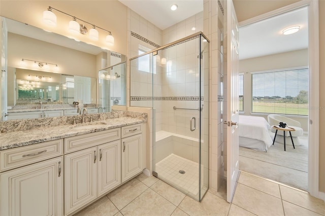 bathroom with vanity, a shower with door, and tile patterned flooring