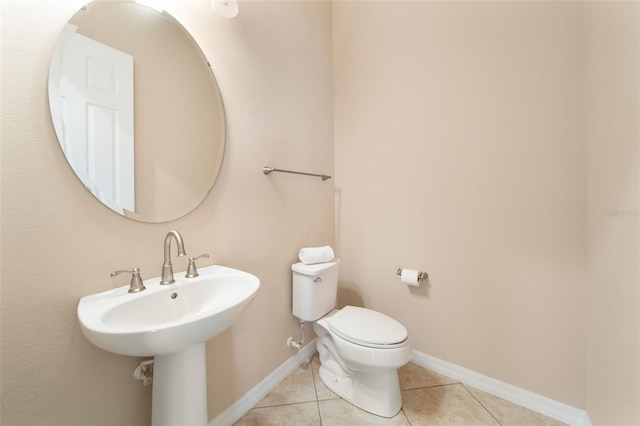 bathroom featuring sink, tile patterned floors, and toilet