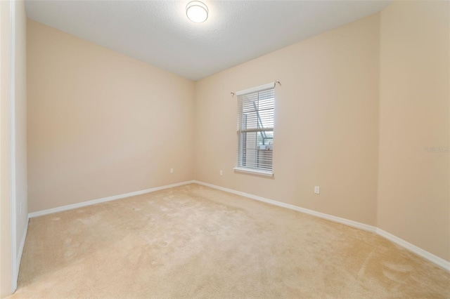 carpeted spare room with a textured ceiling