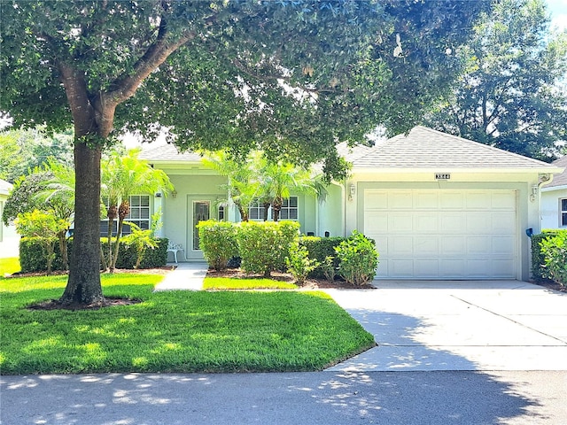 view of front facade featuring a front yard and a garage