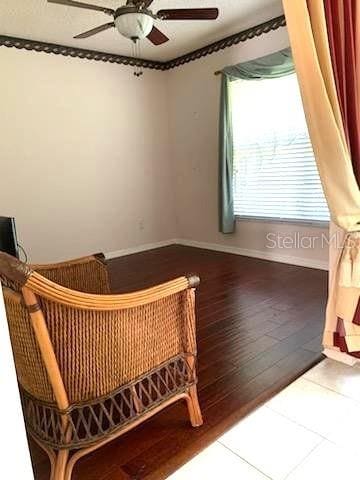 sitting room with hardwood / wood-style flooring and ceiling fan