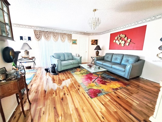 living room featuring wood-type flooring, a textured ceiling, and a chandelier