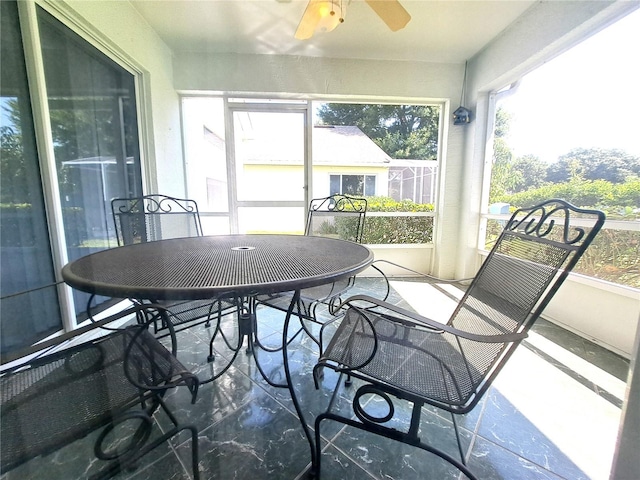 sunroom featuring ceiling fan