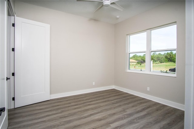 spare room featuring dark hardwood / wood-style floors and ceiling fan