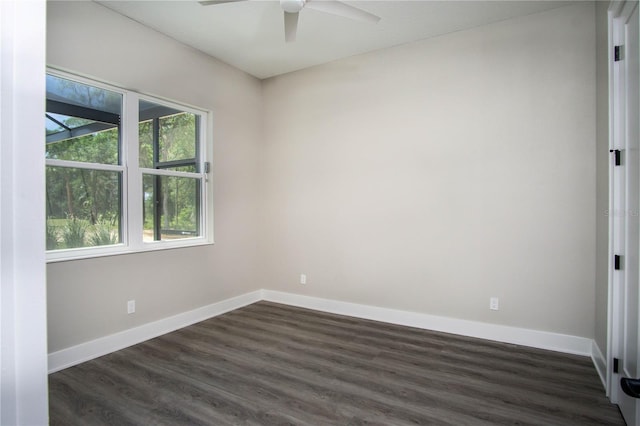 unfurnished room with ceiling fan and dark hardwood / wood-style flooring