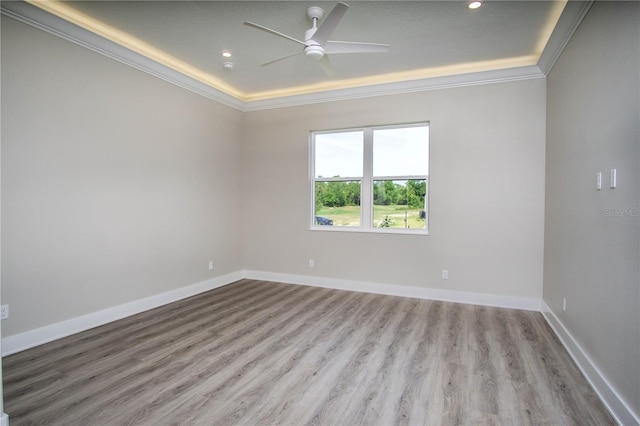 unfurnished room with hardwood / wood-style flooring, ornamental molding, and ceiling fan