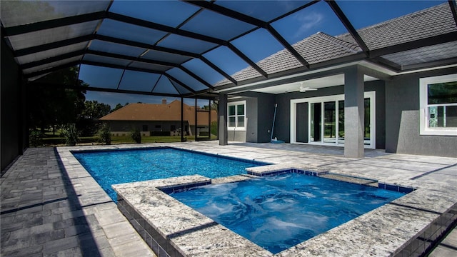 view of pool featuring an in ground hot tub, a patio, a lanai, and ceiling fan