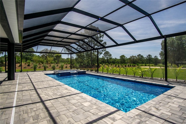 view of swimming pool featuring a patio area, a lanai, and an in ground hot tub