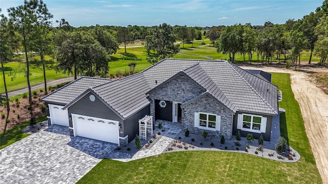 view of front of house with a garage and a front lawn