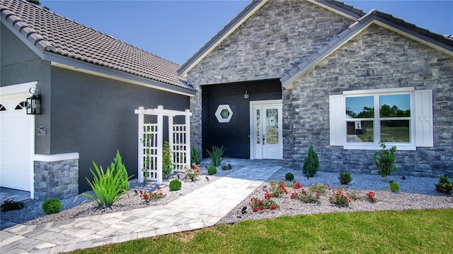 exterior space with a garage and french doors