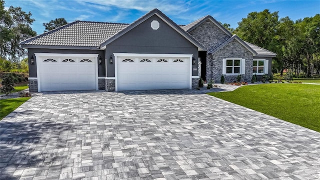 view of front of property with a garage and a front lawn