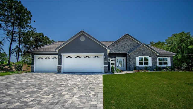 17694 SW 61st Lane Rd, Dunnellon, FL 34432 - view of front of house with stone siding, a tile roof, a front lawn, and a garage