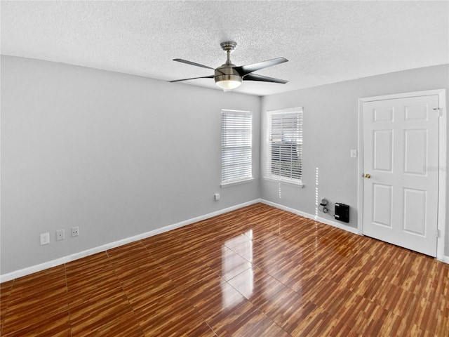 spare room featuring hardwood / wood-style floors, ceiling fan, and a textured ceiling