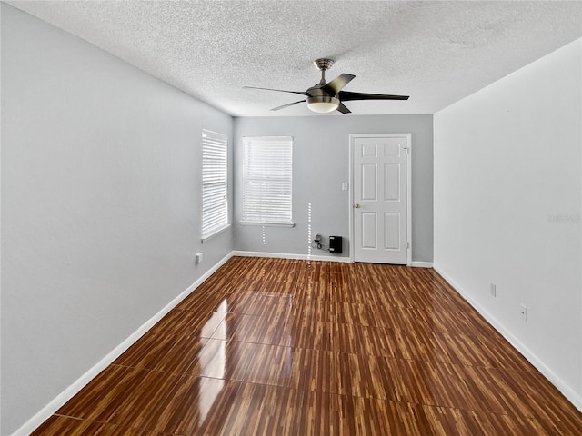 unfurnished room with hardwood / wood-style floors, ceiling fan, and a textured ceiling