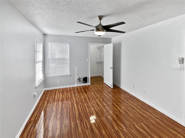 spare room featuring hardwood / wood-style floors, ceiling fan, and a textured ceiling