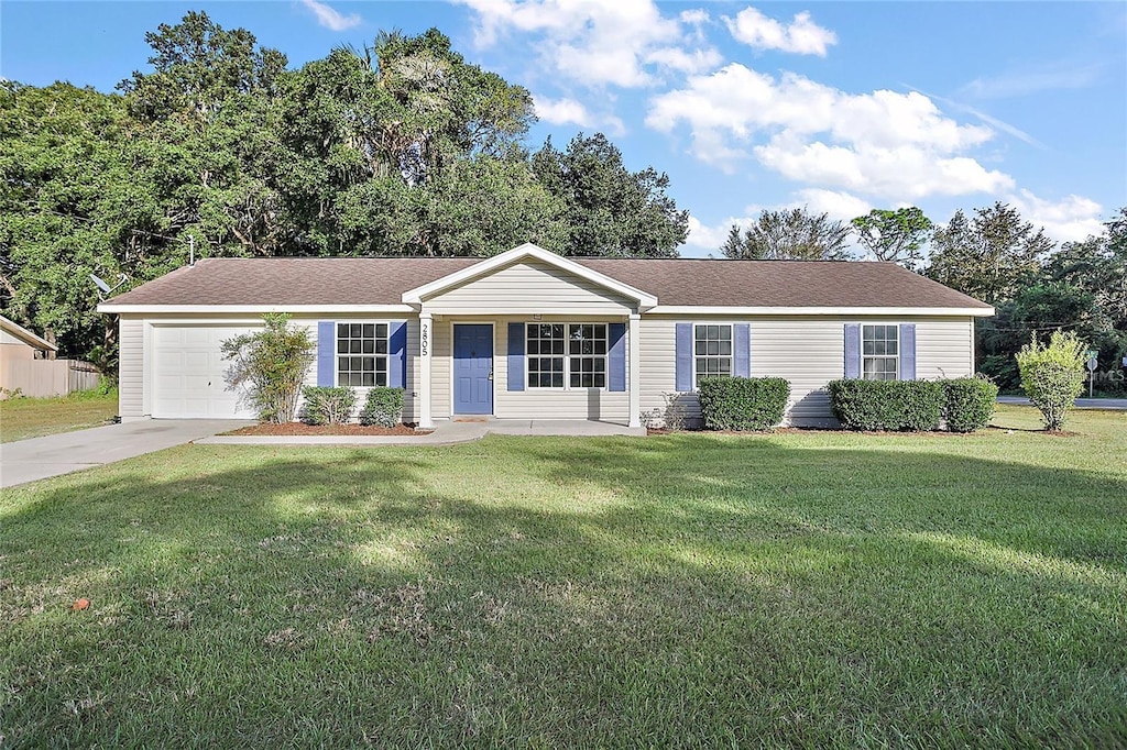 single story home featuring a front lawn, a porch, and a garage