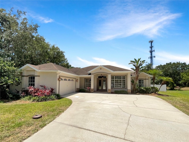 view of front of property with a garage, french doors, and a front lawn