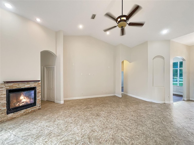 unfurnished living room with ceiling fan, a fireplace, and high vaulted ceiling