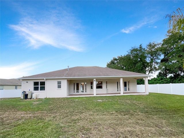 back of house featuring a yard and a patio