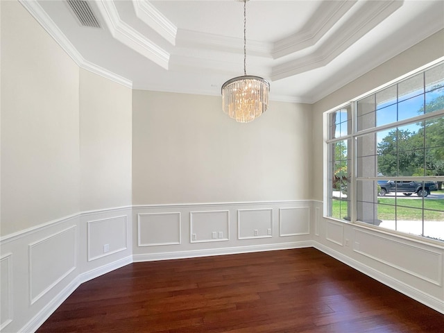 spare room with a chandelier, crown molding, a wealth of natural light, and dark wood-type flooring