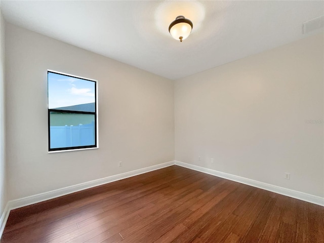 spare room featuring dark wood-type flooring