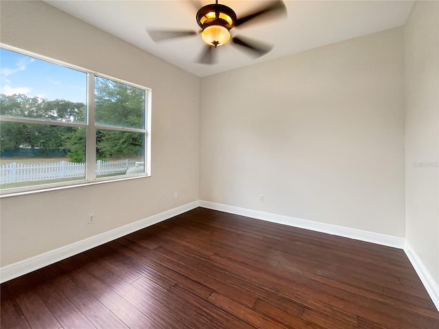 empty room featuring ceiling fan and dark wood-type flooring