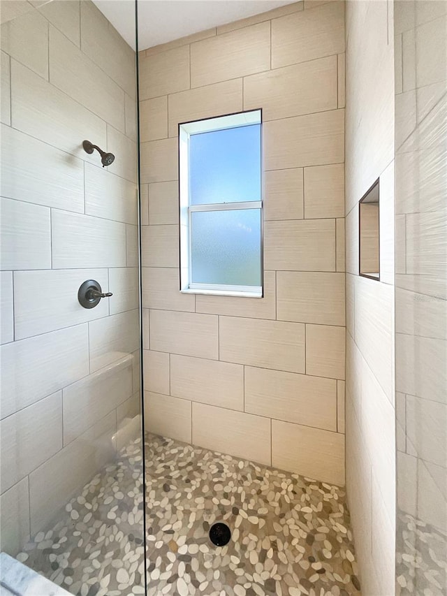 bathroom with tiled shower