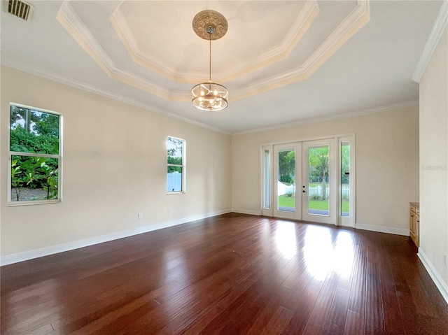 unfurnished room with ornamental molding, french doors, a wealth of natural light, and dark wood-type flooring