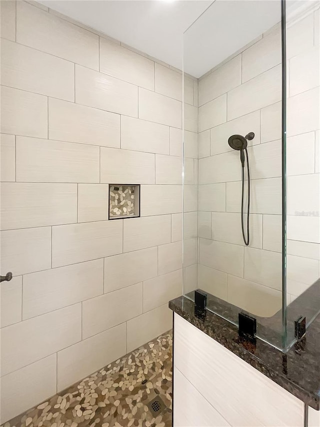 bathroom with a tile shower