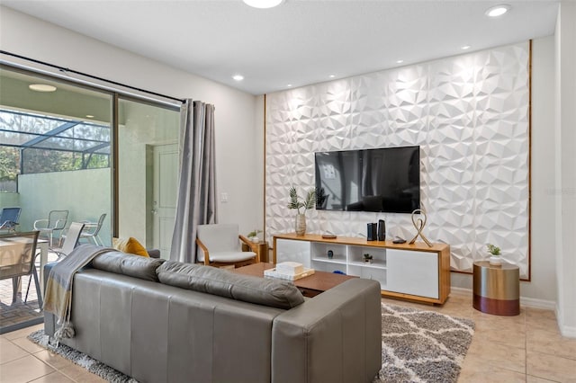 living area with tile patterned flooring, an accent wall, baseboards, and recessed lighting