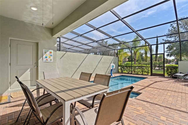 view of patio featuring a lanai, an outdoor pool, and outdoor dining area