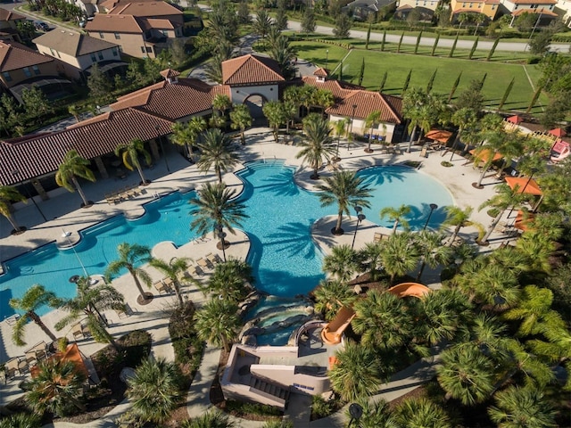 pool featuring a patio area, a residential view, and a yard