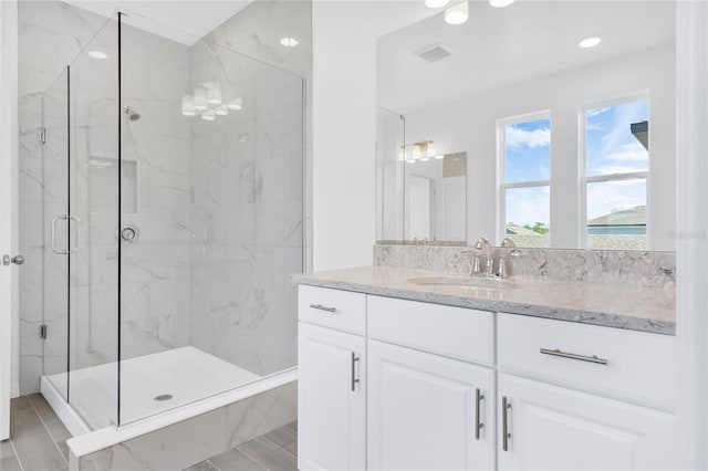 bathroom with vanity and an enclosed shower