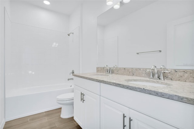 full bathroom featuring vanity, shower / bathtub combination, and toilet