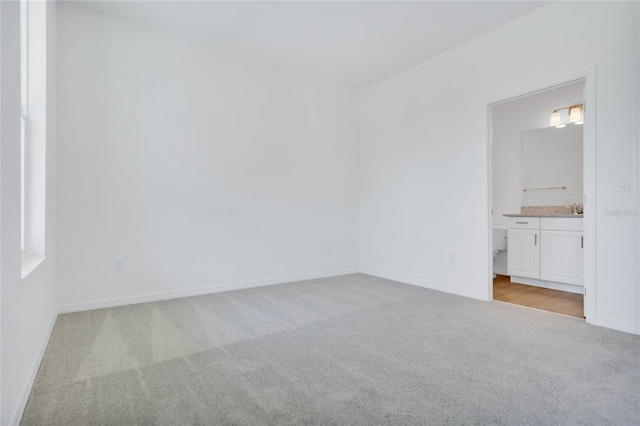 carpeted spare room with sink