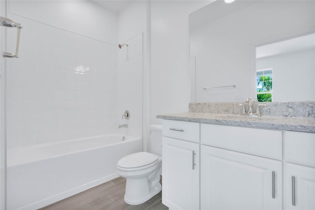 full bathroom with wood-type flooring, vanity, toilet, and tiled shower / bath