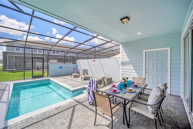 view of swimming pool with a lanai and a patio area