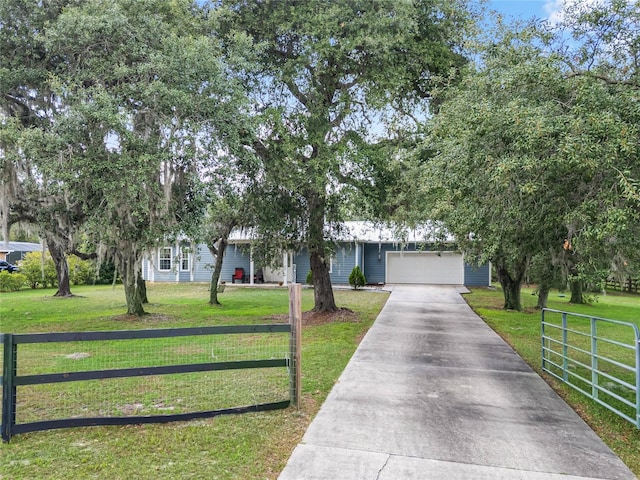 view of front of house with a garage and a front lawn