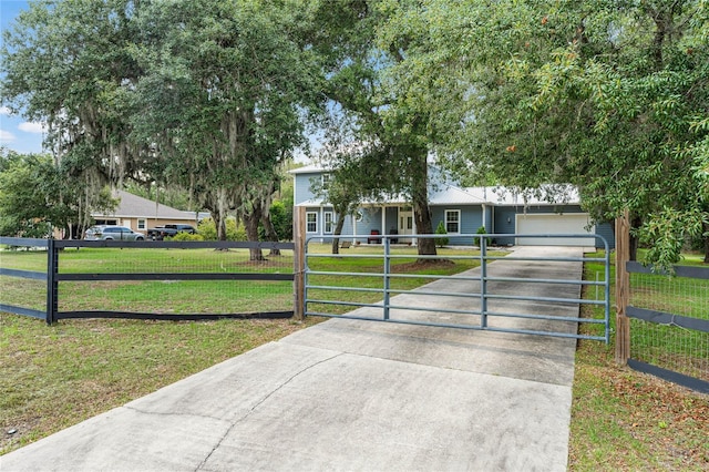 ranch-style home with a garage and a front lawn