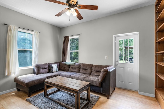 living room featuring ceiling fan, a healthy amount of sunlight, and light hardwood / wood-style floors